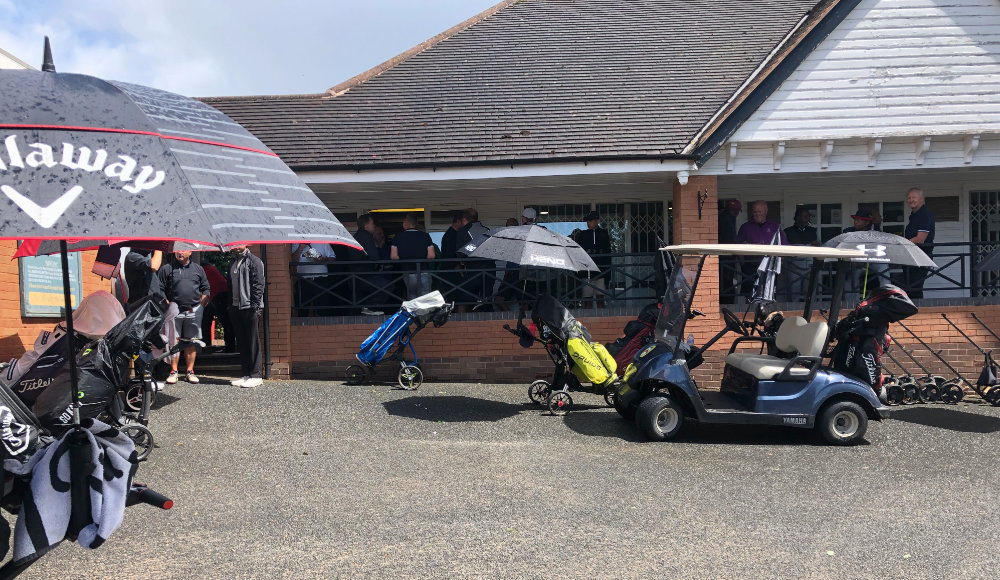 Golfers taking shelter from the rain